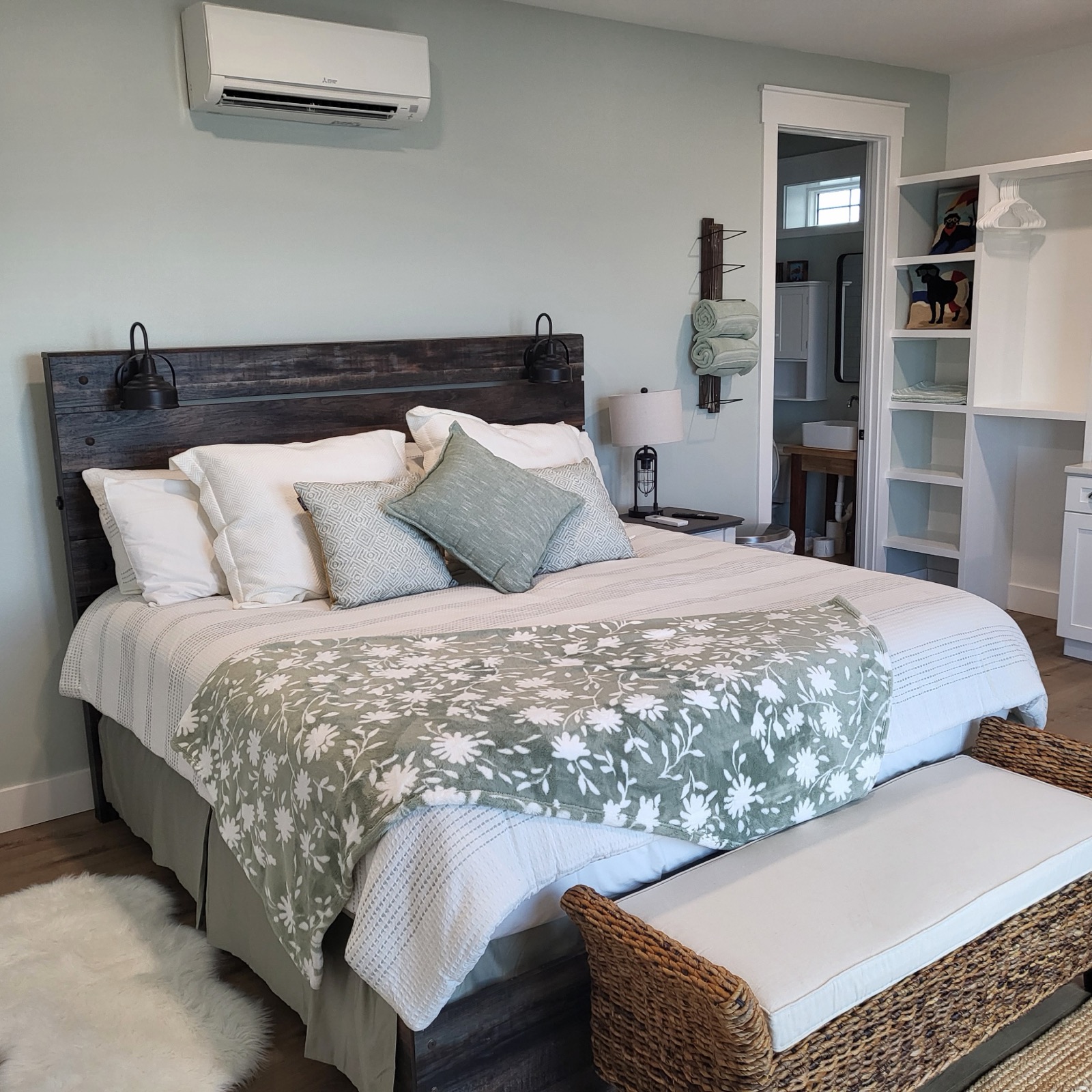 King bed and sea-glass coastal interior in Unit 1